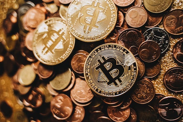 bitcoin on a pile of other gold coins